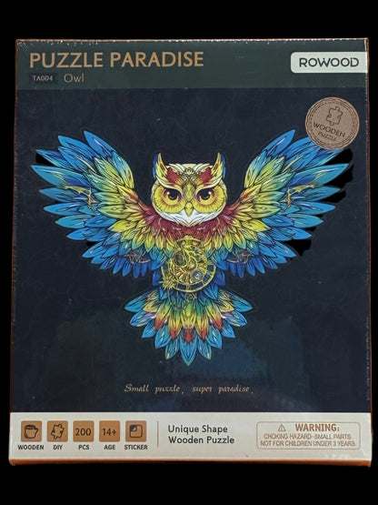 Jigsaw puzzle box with a colorful owl design on an orange background