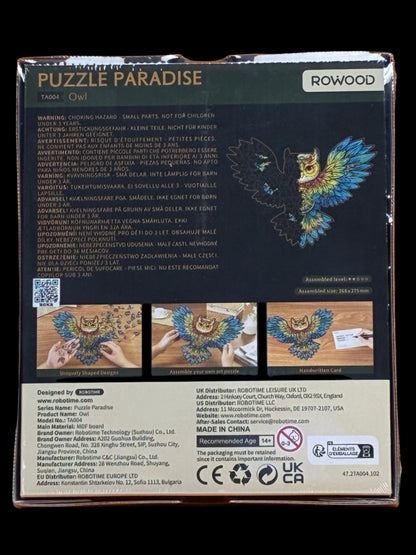 Back of a puzzle packaging with 'Puzzle Paradise' branding and owl design.